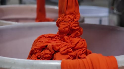 Bright Orange Fabric Collapsing into Laundry Tub
