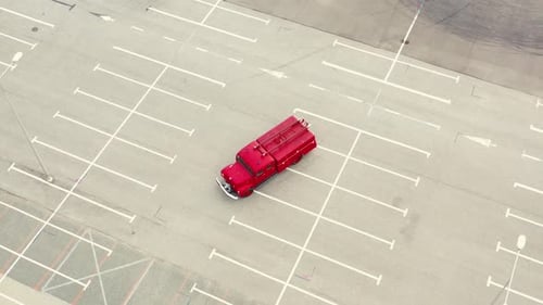 Classic Red Firetruck Parked on Empty Lot Aerial