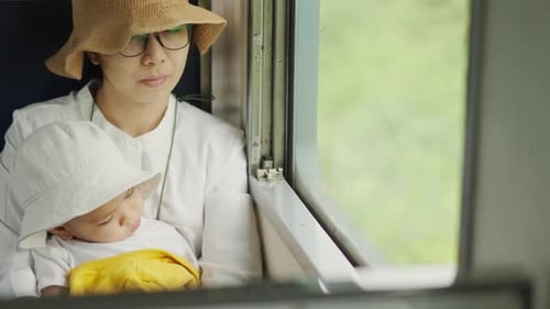Mother and Sleeping Child on Train Journey