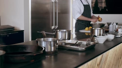 Chef Peeling a Potato in a Professional Kitchen