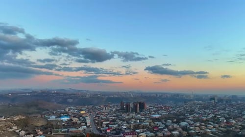 A city skyline with a beautiful sunset in the background