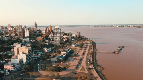 Drone approaching Costanera Avenue in Posadas, Misiones, Argentina, revealing the scenic waterfront