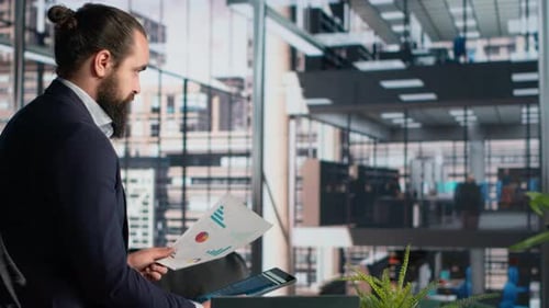 Bearded Businessman Looking at Data in Office