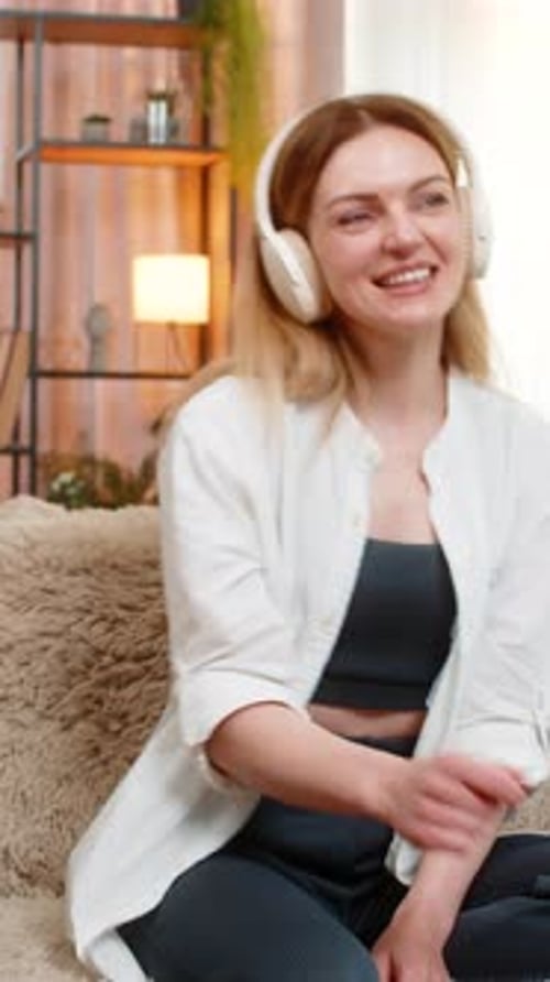Woman Listening to Music on Headphones and Dancing
