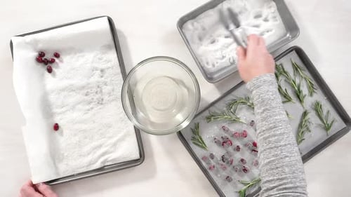 Step By Step Flat Lay Covering Fresh Cranberries and Rosemary in Sugar to Decorate Chocolate Bundt