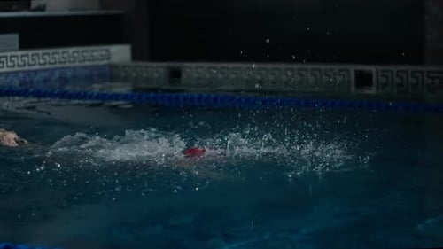 Professional Swimming Sport Athletic Woman In Red Swimsuit Swimming Butterfly Style In Pool