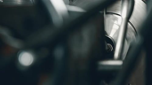 Spinning industrial machinery with moving parts in factory
