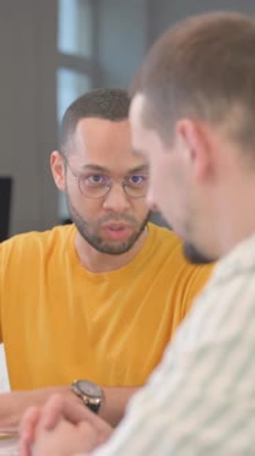 Close up of Mixed Race Man Talking with Teammates, vertical video