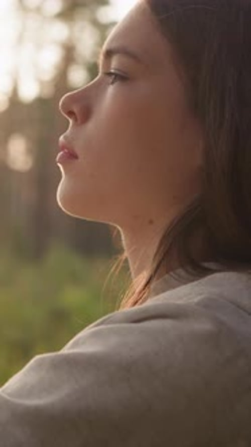 Sad Lady Rests Leaning on Tree Trunk