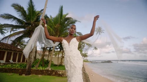 Elegant Person in White Dress Posing Near Beach