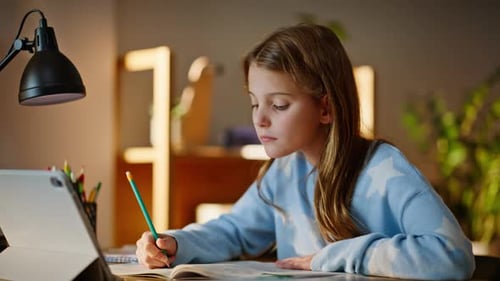 Girl Studies with Tablet and Pencil at Desk