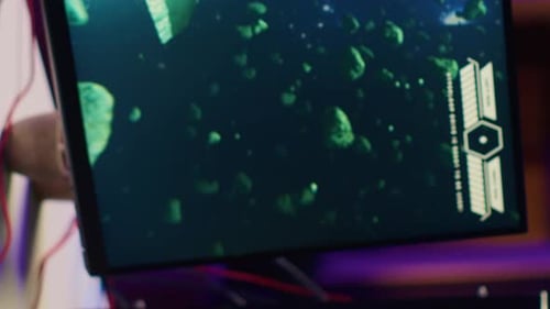 Vertical Video Close Up Shot of Computer Screen Showing Spaceship Flying Singleplayer