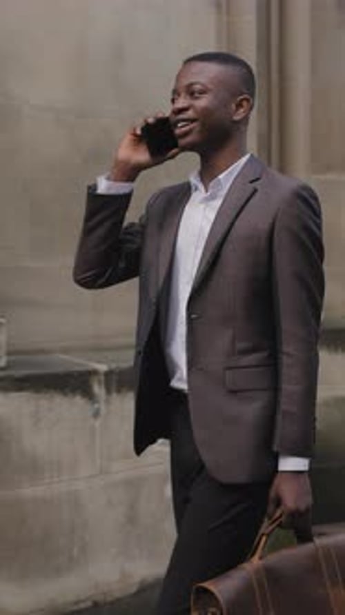 Afro American Man in Suit Talking on Mobile on Street