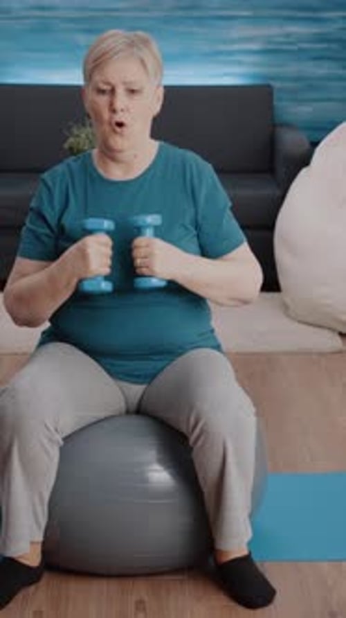 Senior Woman Exercising with Dumbbells at Home