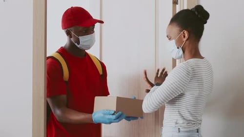 Delivery Man Giving Package to Woman at Door