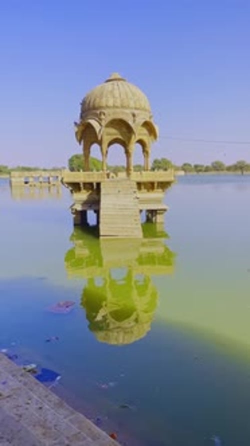 Gadsisar Lake glows in golden sun, reflecting ancient pavilions serene escape in Jaisalmer’s desert