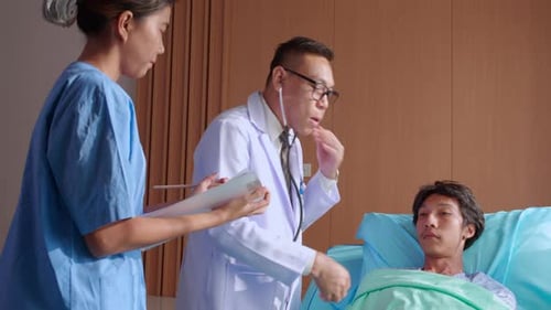 Doctor Examines Patient in Hospital Room with Nurse