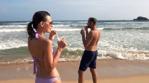Young Couple Drinking Cocktails on Beach Near Sea Super 240