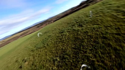 FPV Racing. First-person View Drone Flying Over Field With Arch Gates.