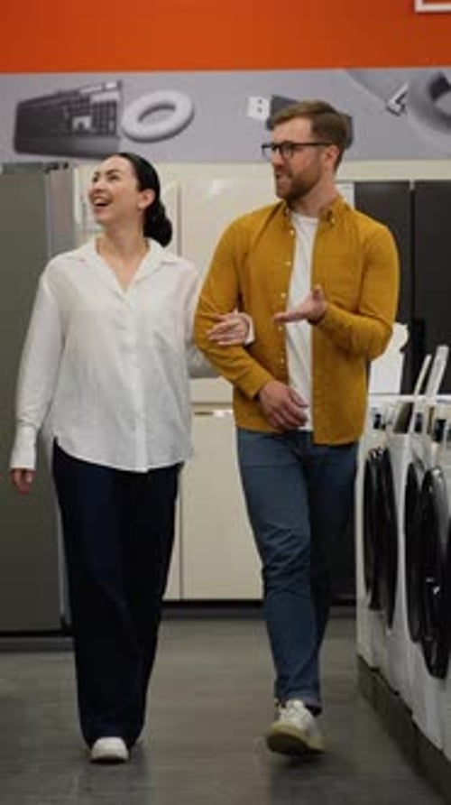 Young Couple in Appliances Store Choose to Buy Fridge for Home Vertical Video