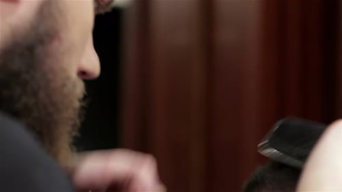 Barber Cuts Man's Hair with Clippers