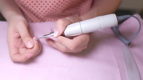 Detailed Nail Treatment Woman Manicurist Ensuring Nail Health with Close Up Precision