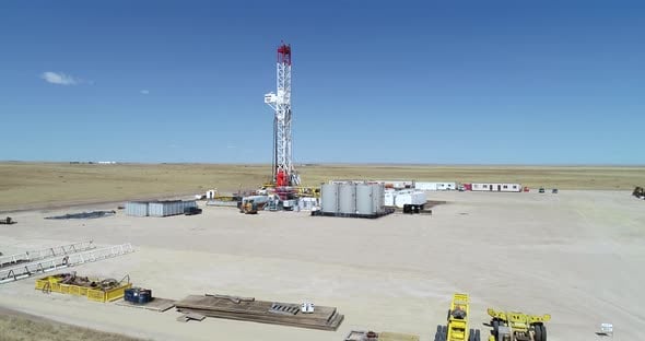 Big rig oil drilling fracking pad tower approach. Drone 4k 60fps ...