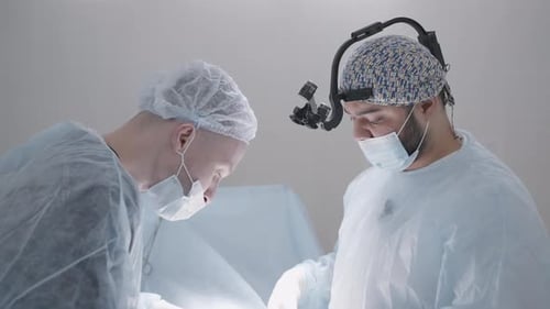 Two Surgeons Perform Operation in Operating Room