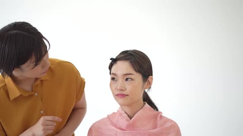 Makeup Artist Applying Cosmetics to Woman's Face