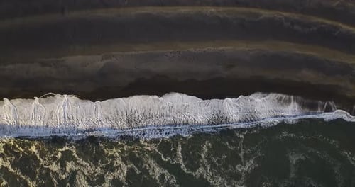 aerial view of icelandic black beach with atlantic ocean waves