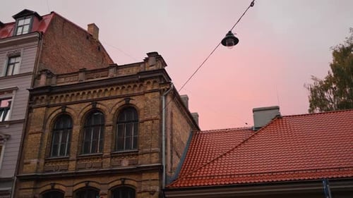 Sunrise Pink Sky Over Old Buildings in City