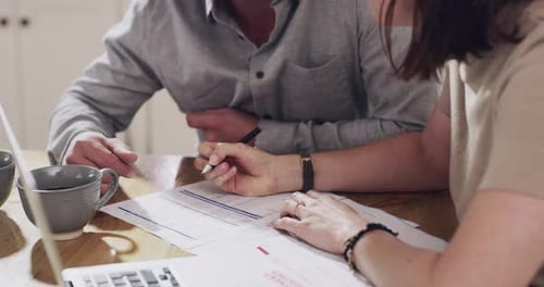 Couple Reviews Finances and Documents at Home