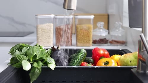 Fresh vegetables and fruits are washed in a special tray for vegetables. Concept of healthy eating