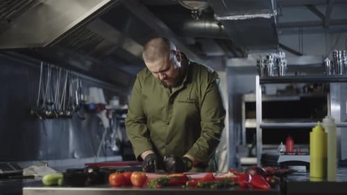 Chef Cutting Vegetables in Commercial Kitchen