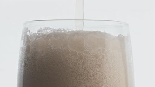 Foamy Beer Stream Pouring Glass Closeup