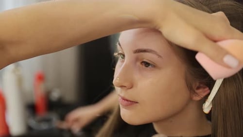 Captivating View of Makeup Being Expertly Applied in a Refined Professional Setting
