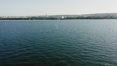 Kitesurfers Enjoying a Sunny Day on the Ocean