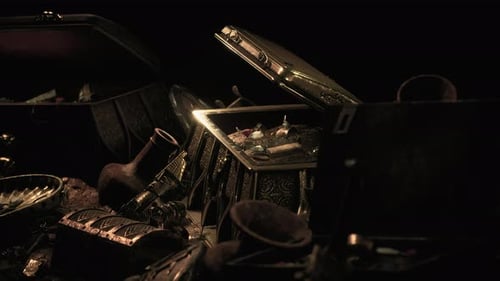 Handful of Gold Jewelry on a Dark Background