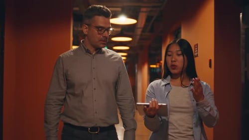 Businessmen Walking Down in Office Corridor