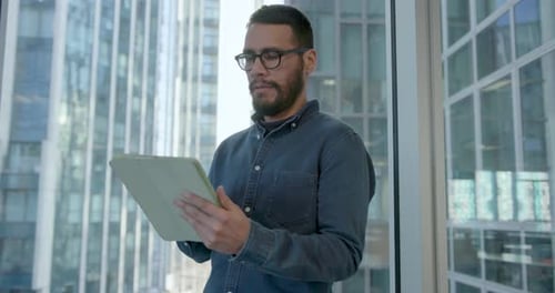 Businessman using Digital Tablet standing in Office