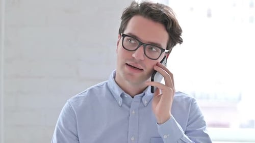 Man Talking on Smartphone in Bright Interior