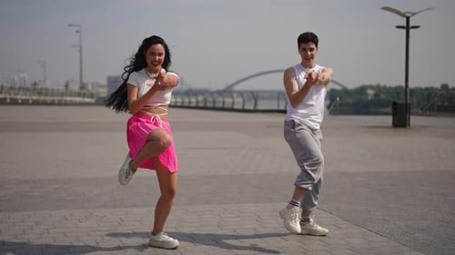 Slow Motion A Cheerful Couple of Street Dancers Shows Their Skills By Dancing Outdoors on a City