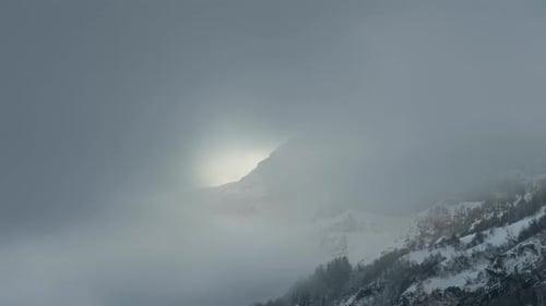 The fog and clouds move over the mountains in winter