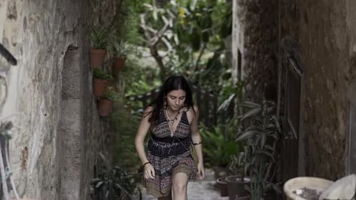Young European Girl Goes Upstairs of a Stone Tunnel in Slowmotion