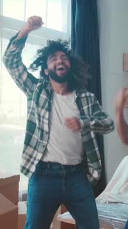 Man and woman dancing in new apartment