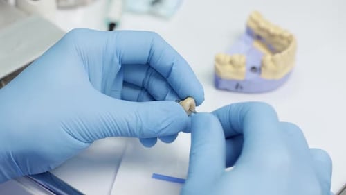 Dentist Adding Parts to Tooth in Clinic Setting