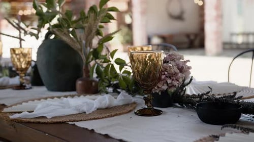 Summer garden party wedding event table with glasses plates and flower pot decorations