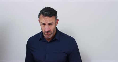 4k video footage of a mature businessman with attitude against a gray studio background