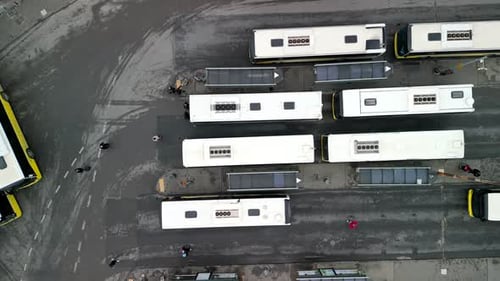 Right to left drone shot of a busy bus terminal station