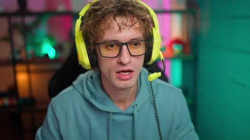 Young Man Streaming Wearing Bright Yellow Headphones